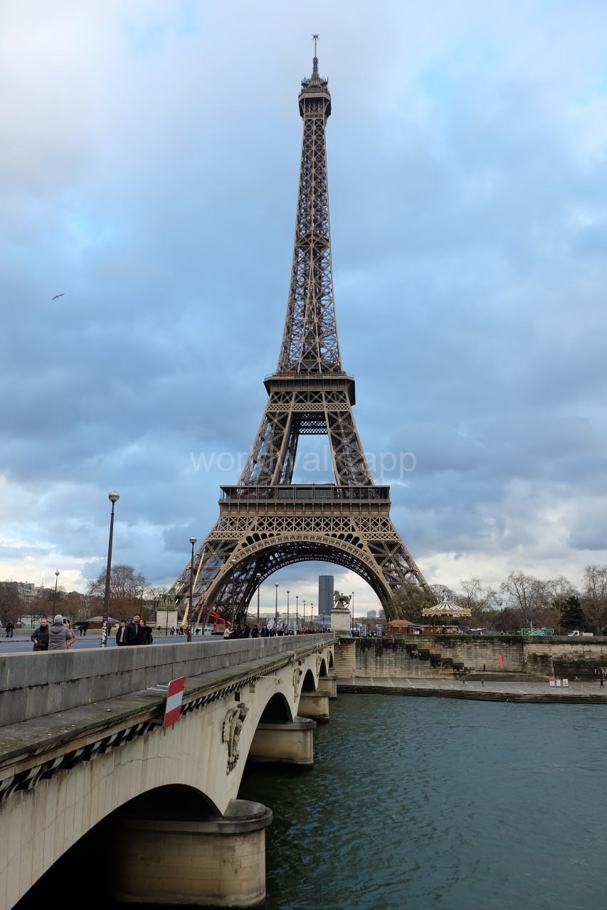Eiffel Tower seen from Pont d’Iéna bridge over the Seine, on the walking approach from Trocadéro